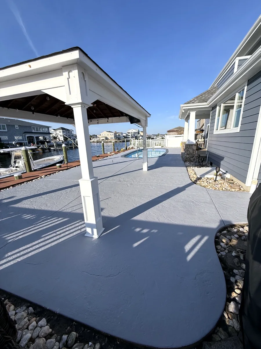 Pool and patio after power washing sealer removal and solid stain